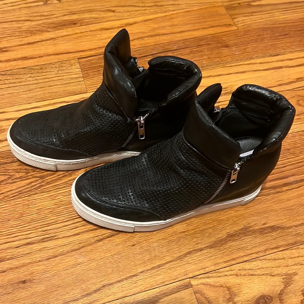 Steve Madden black wedge sneaker with zippers on both sides and white soles
